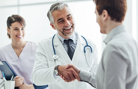 Doctor shaking hands with a patient (Photo)