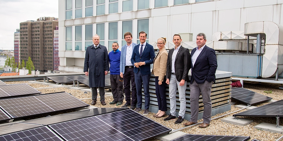 Bernhard Spitaler, Wolf Gerlach, Andrea Sternberg, Stephan Neuberger, and Ernst Beiszer inspecting the installation of a new photovoltaic system at the Vienna headquarters. The system generates 100,000 kWh of solar power annually and saves 21 tons of CO₂.

